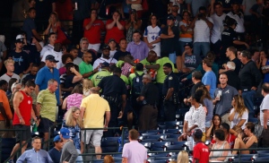 Emergency medical staff help a fan that fell from the upper deck of Turner Field during the game between the Atlanta Braves and the New York Yankees on Saturday, Aug. 29, 2015, in Atlanta. (Credit: Mike Zarrilli/Getty Images) 